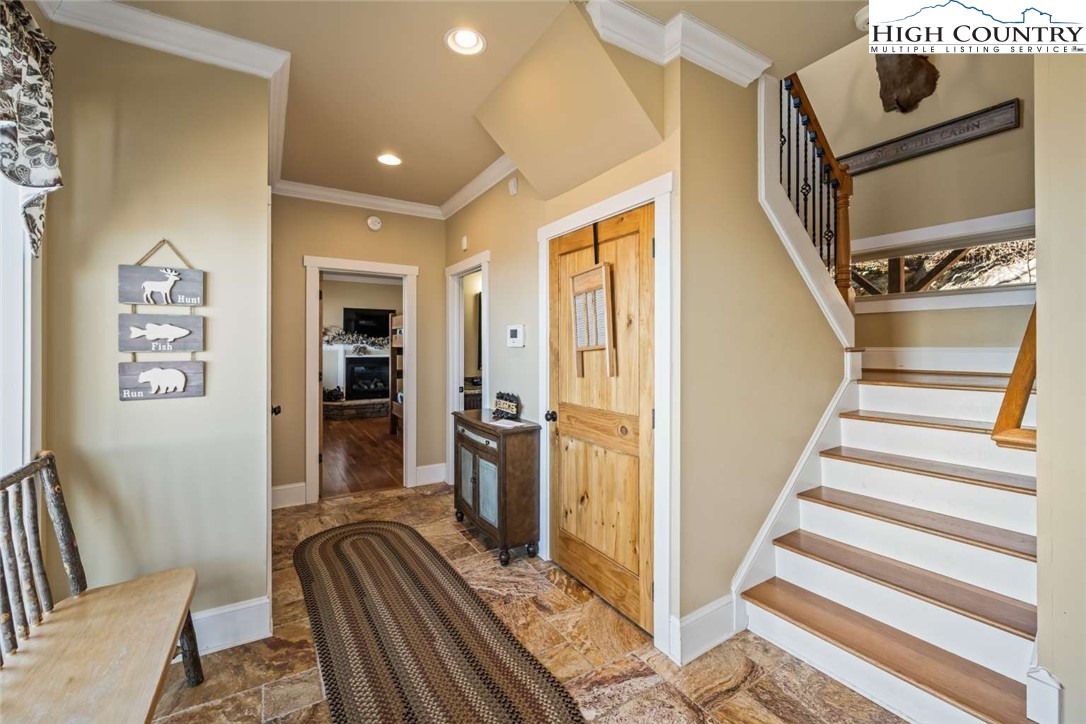 585 Stony Fork Road West Jefferson, NC 28694 - Photo 3 of 25 a view of a hallway with wooden floor and staircase