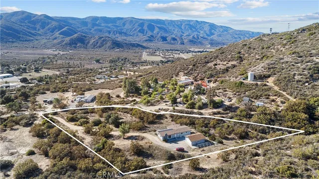 an aerial view of house with mountain view