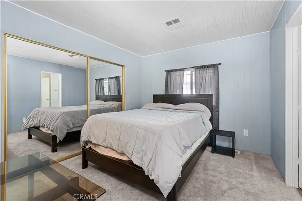 a spacious bedroom with a bed and a window