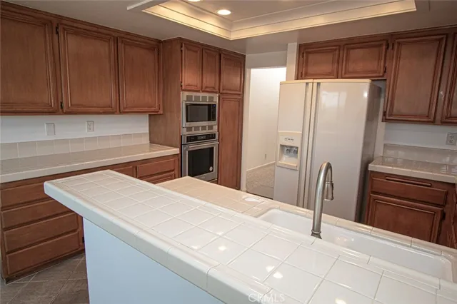 a kitchen with stainless steel appliances a refrigerator and cabinets