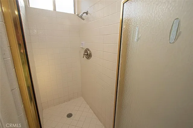 a bathroom with a glass shower door