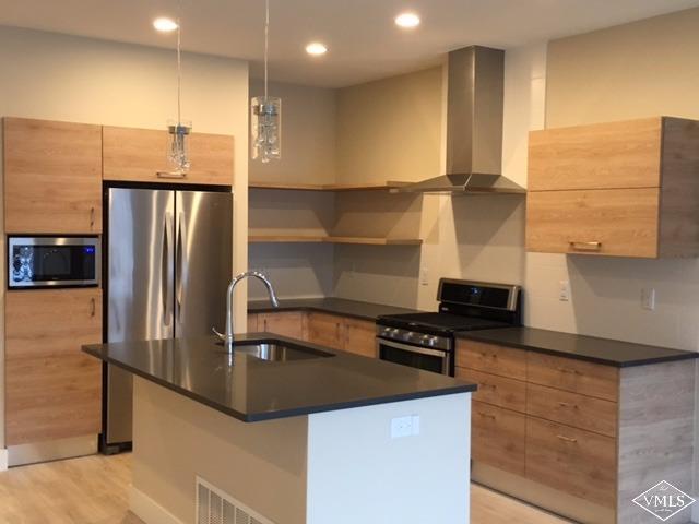 76 Lynx Circle Gypsum, CO 81637 - Photo 7 of 17 a kitchen with stainless steel appliances a sink a stove and a refrigerator