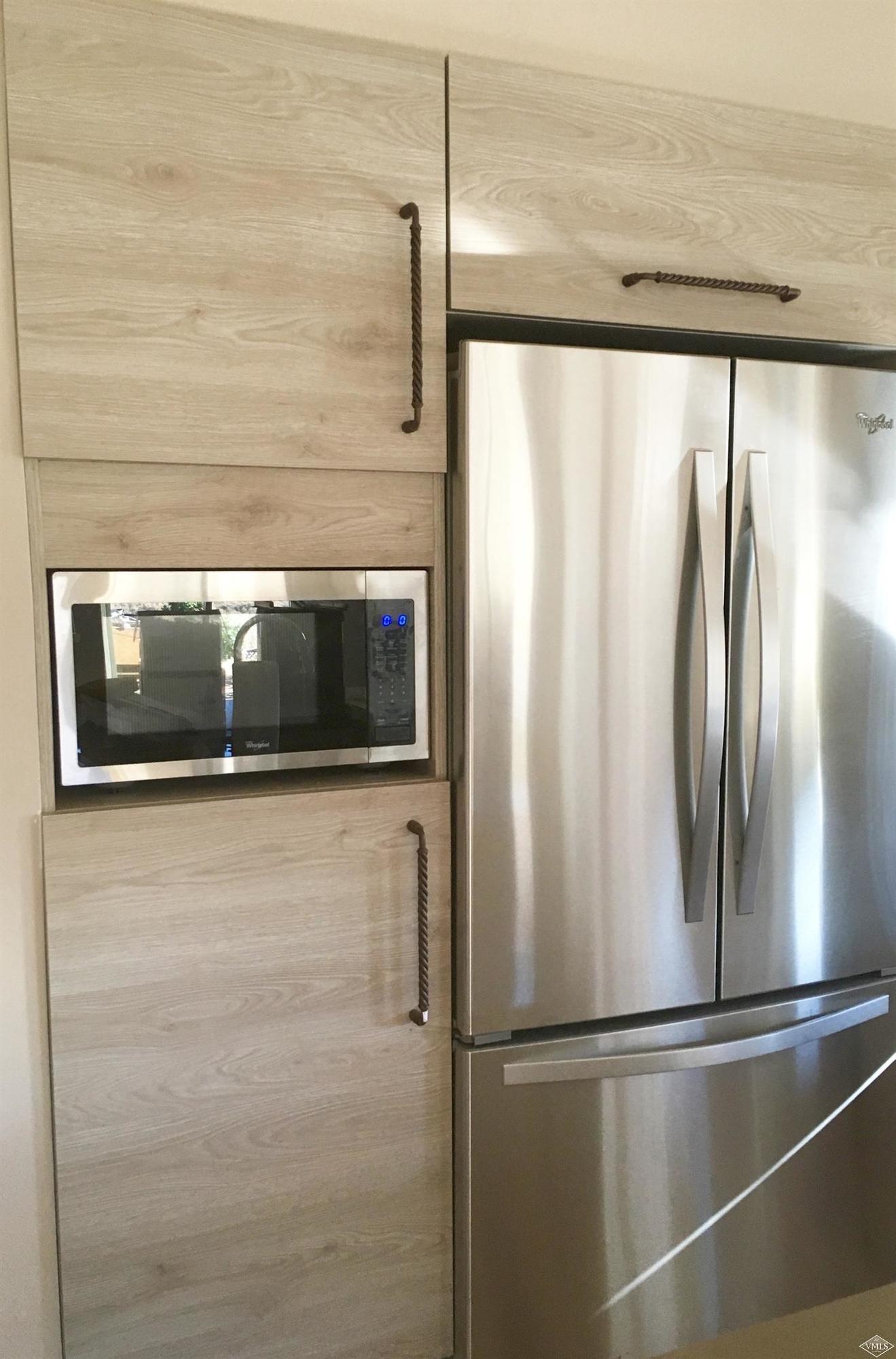 76 Lynx Circle Gypsum, CO 81637 - Photo 8 of 17 a view of a refrigerator in kitchen and an empty room