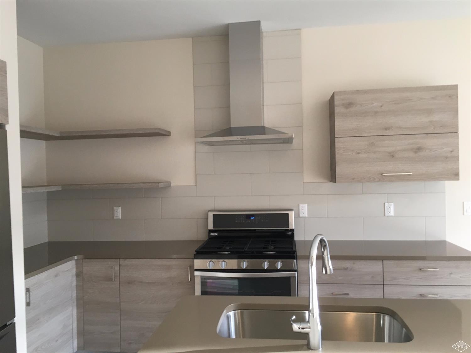 76 Lynx Circle Gypsum, CO 81637 - Photo 10 of 17 a kitchen with granite countertop a stove and a cabinets