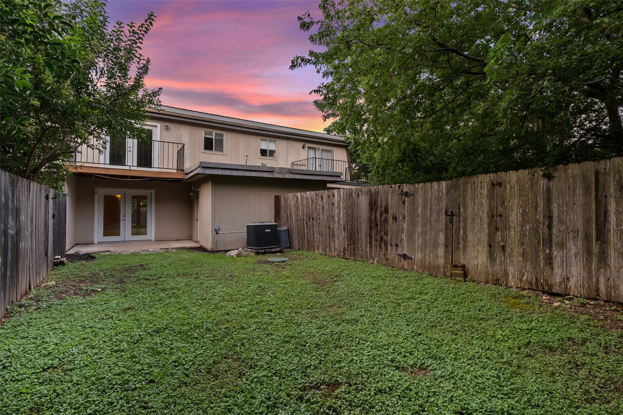 702 Castle Ridge Road, Unit C Austin, TX 78746 - Photo 21 of 36 The fenced backyard offers privacy and room to relax.