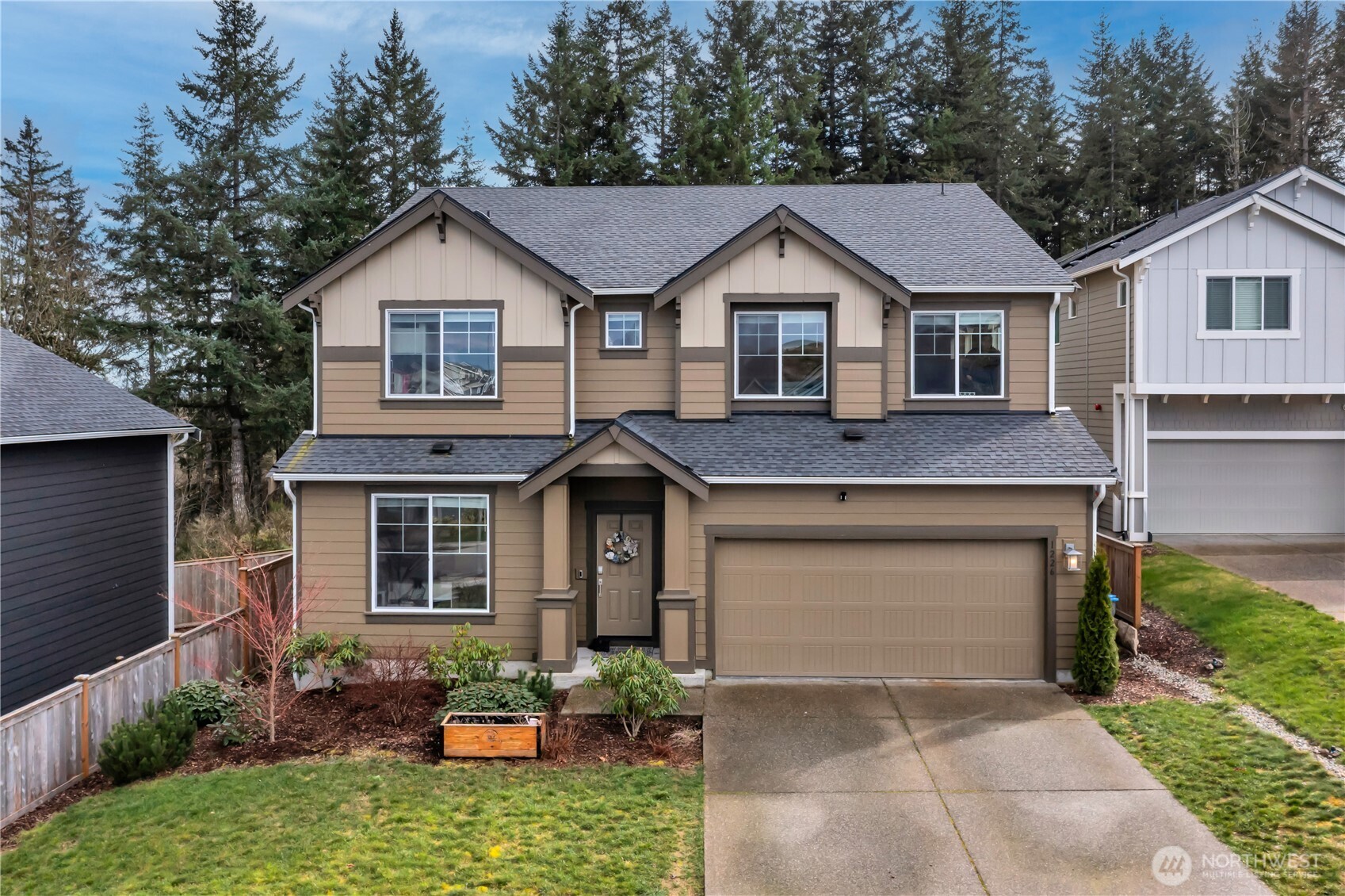 1226 Baker Hts Loop Bremerton, WA 98312 - Photo 1 of 40 a front view of a house with a yard and garage