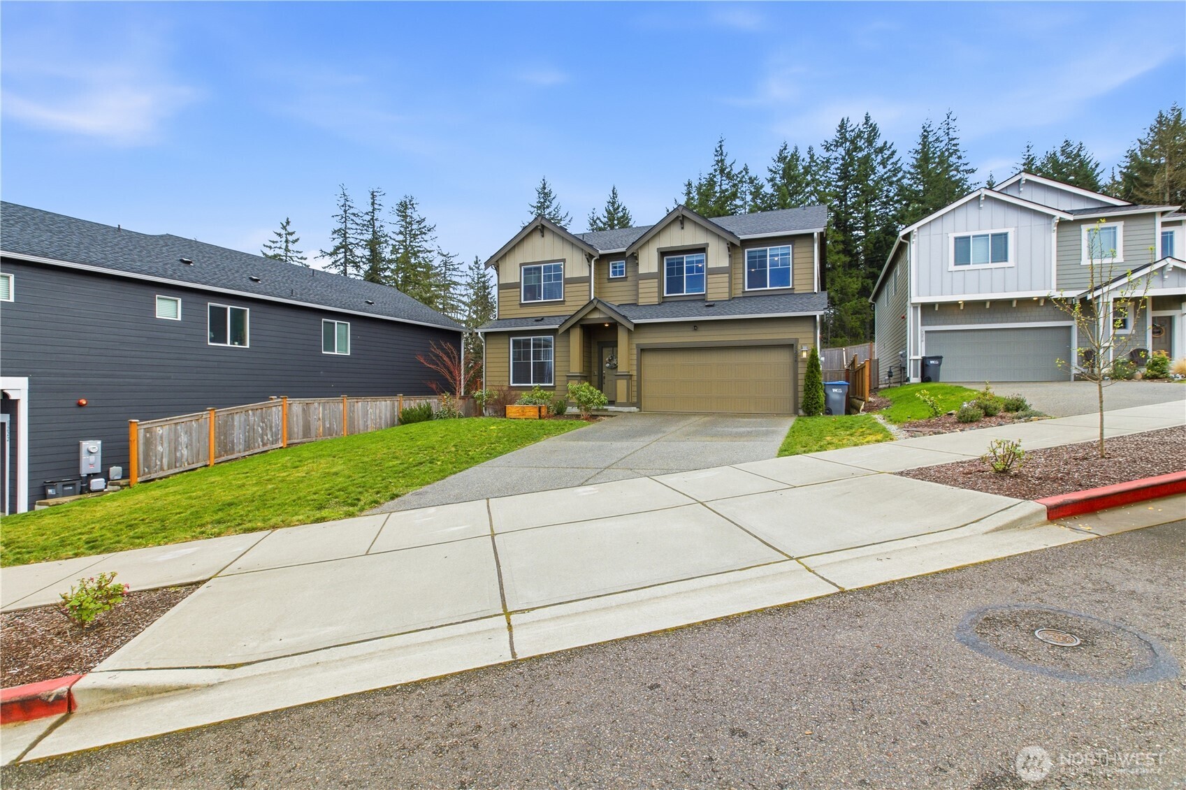 1226 Baker Hts Loop Bremerton, WA 98312 - Photo 2 of 40 a front view of a house with a yard and potted plants