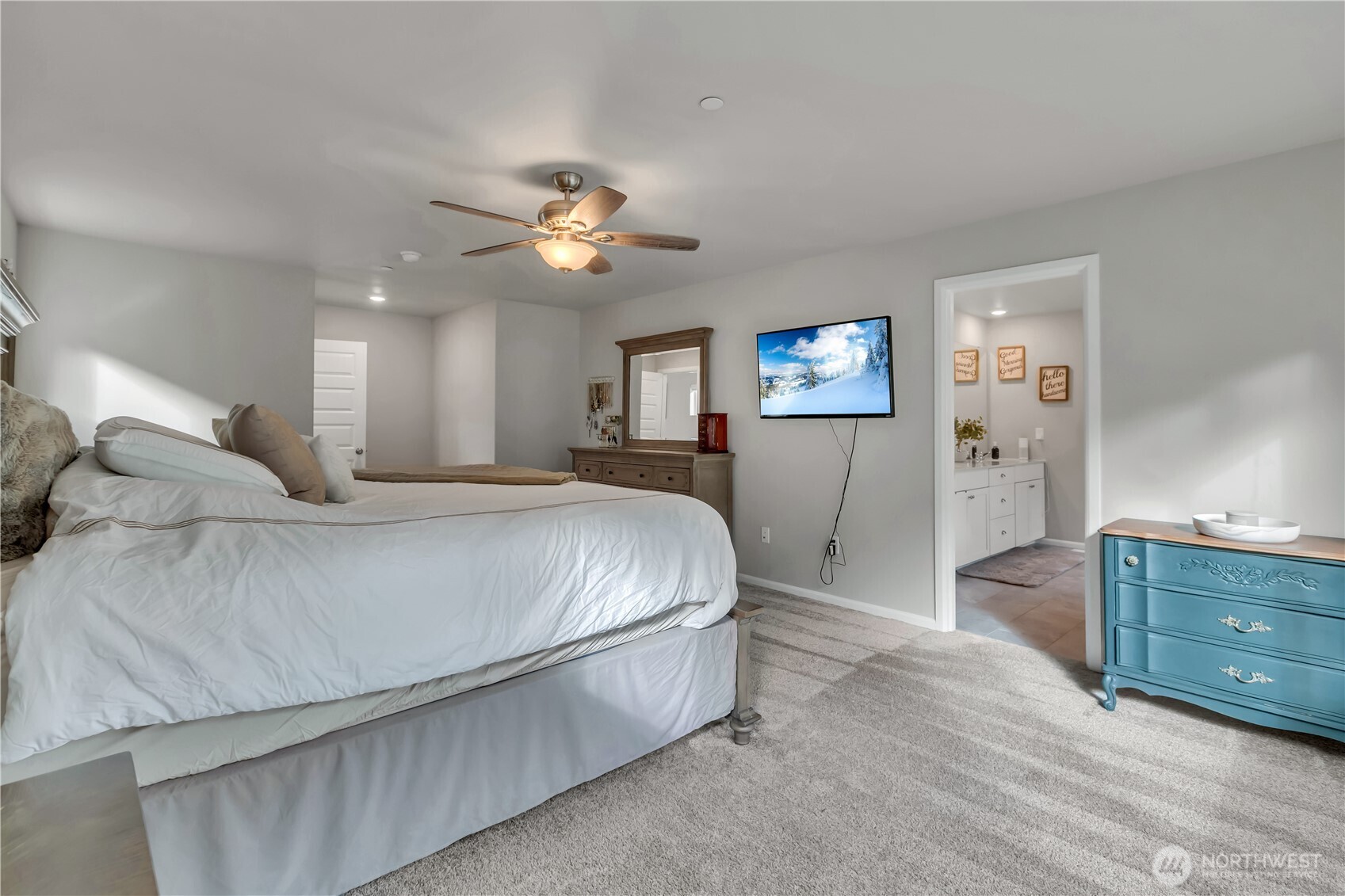 1226 Baker Hts Loop Bremerton, WA 98312 - Photo 24 of 40 a spacious bedroom with a bed and a chandelier