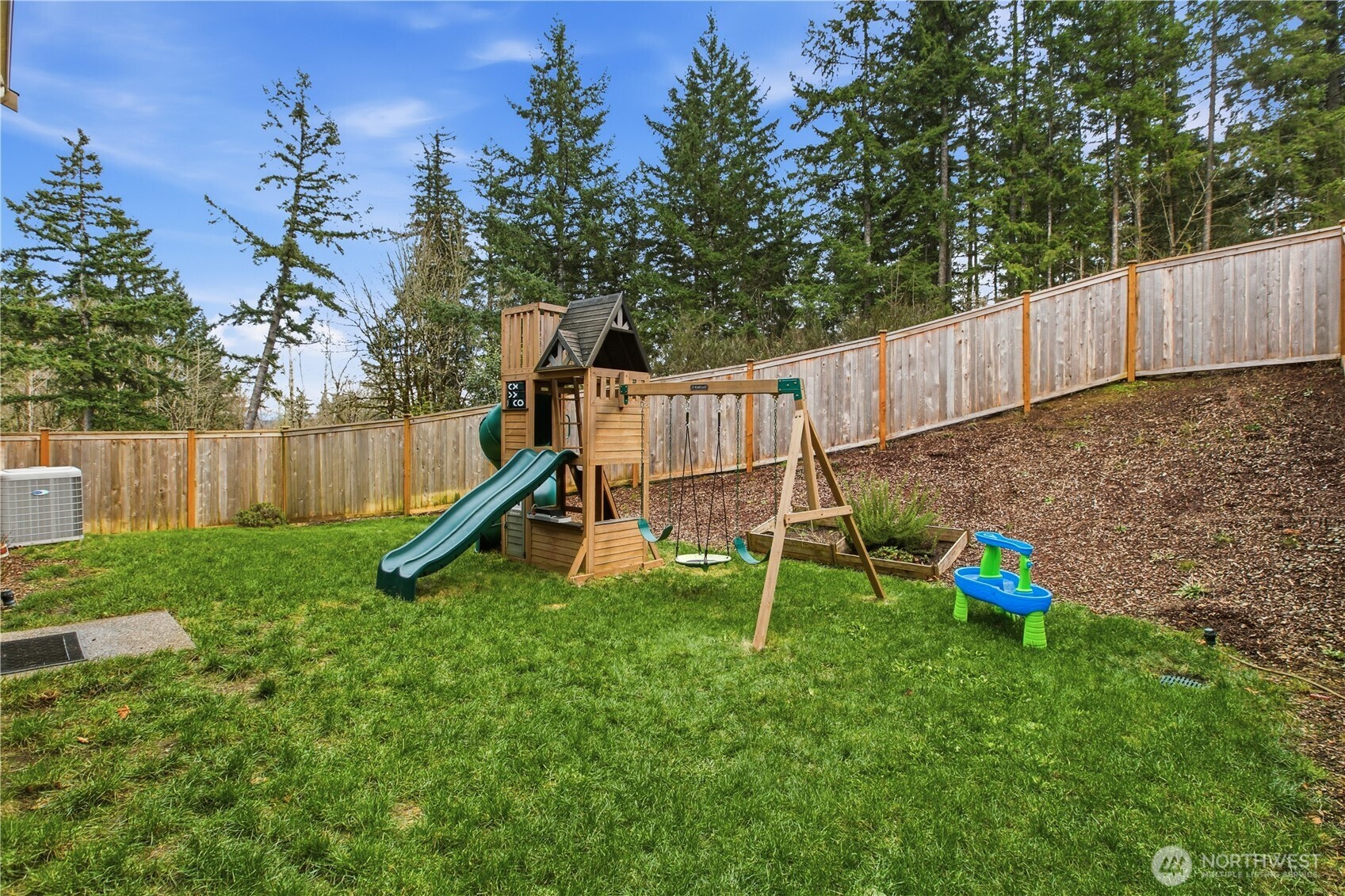 1226 Baker Hts Loop Bremerton, WA 98312 - Photo 36 of 40 a view of outdoor space with a wooden fence and a slide