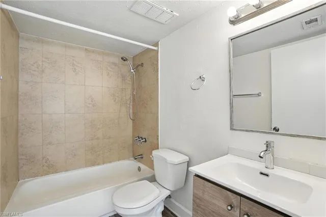 a kitchen with stainless steel appliances granite countertop a sink and a refrigerator