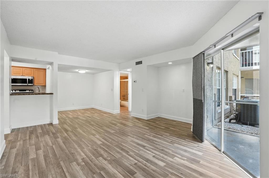 201-5 Santa Clara Drive, Unit 201 Naples, FL 34104 - Photo 16 of 23 a view of empty room with wooden floor
