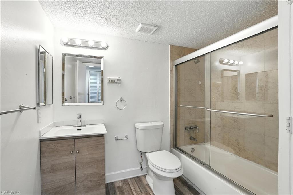 201-5 Santa Clara Drive, Unit 201 Naples, FL 34104 - Photo 18 of 23 a bathroom with a granite countertop sink toilet and shower