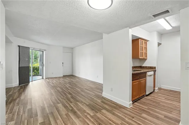 a view of an empty room and wooden floor