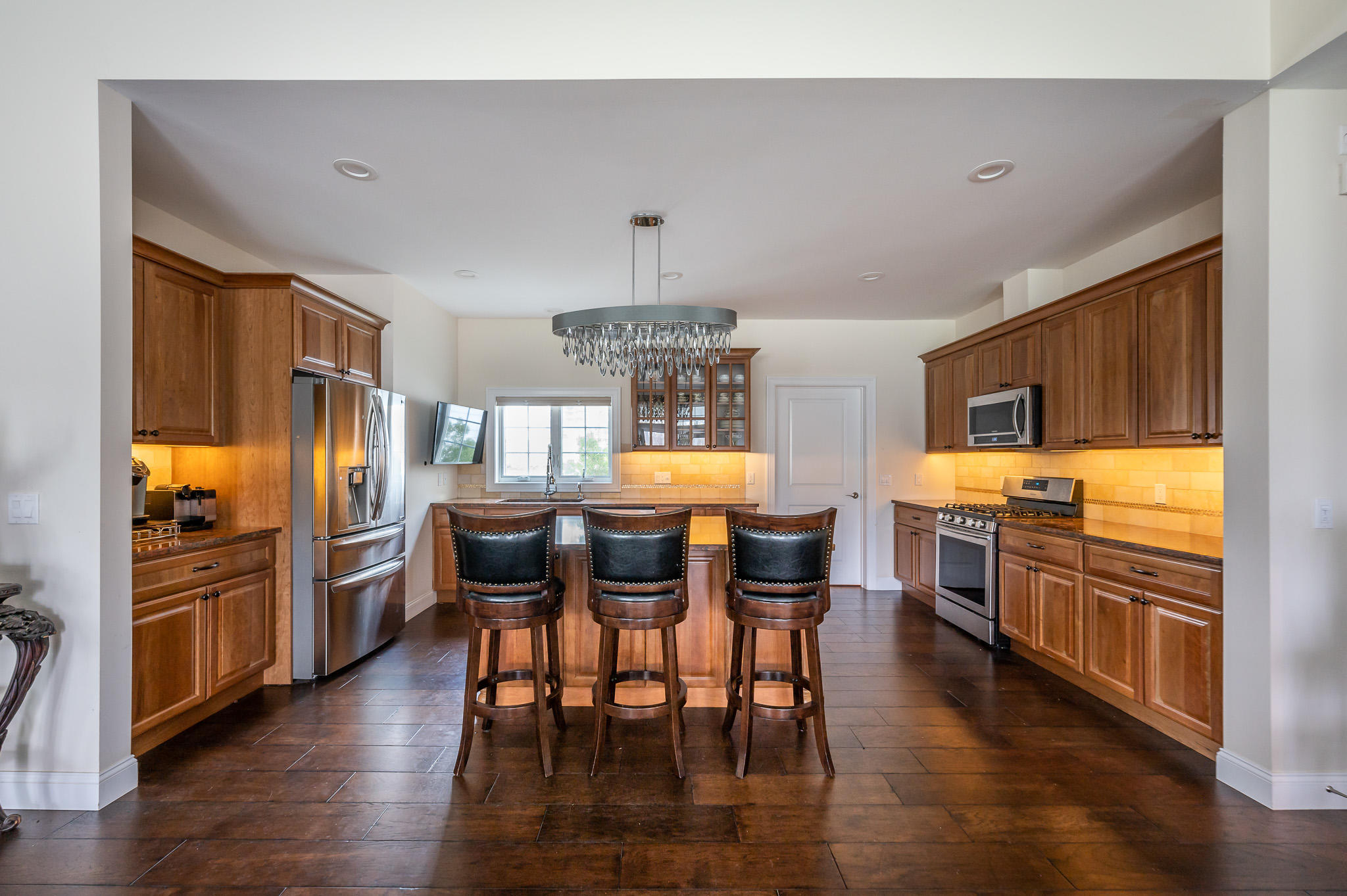16 Burning Tree Road Great Barrington, MA 01230 - Photo 12 of 39 a kitchen with stainless steel appliances wooden floor and dining table