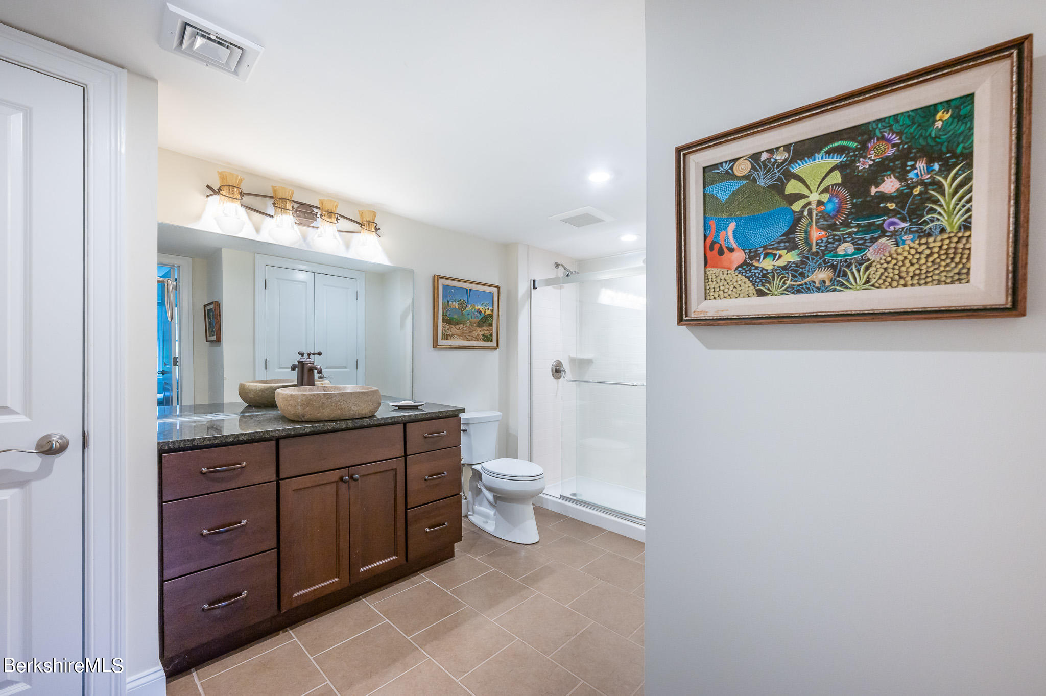 16 Burning Tree Road Great Barrington, MA 01230 - Photo 27 of 39 a spacious bathroom with a toilet a sink and mirror