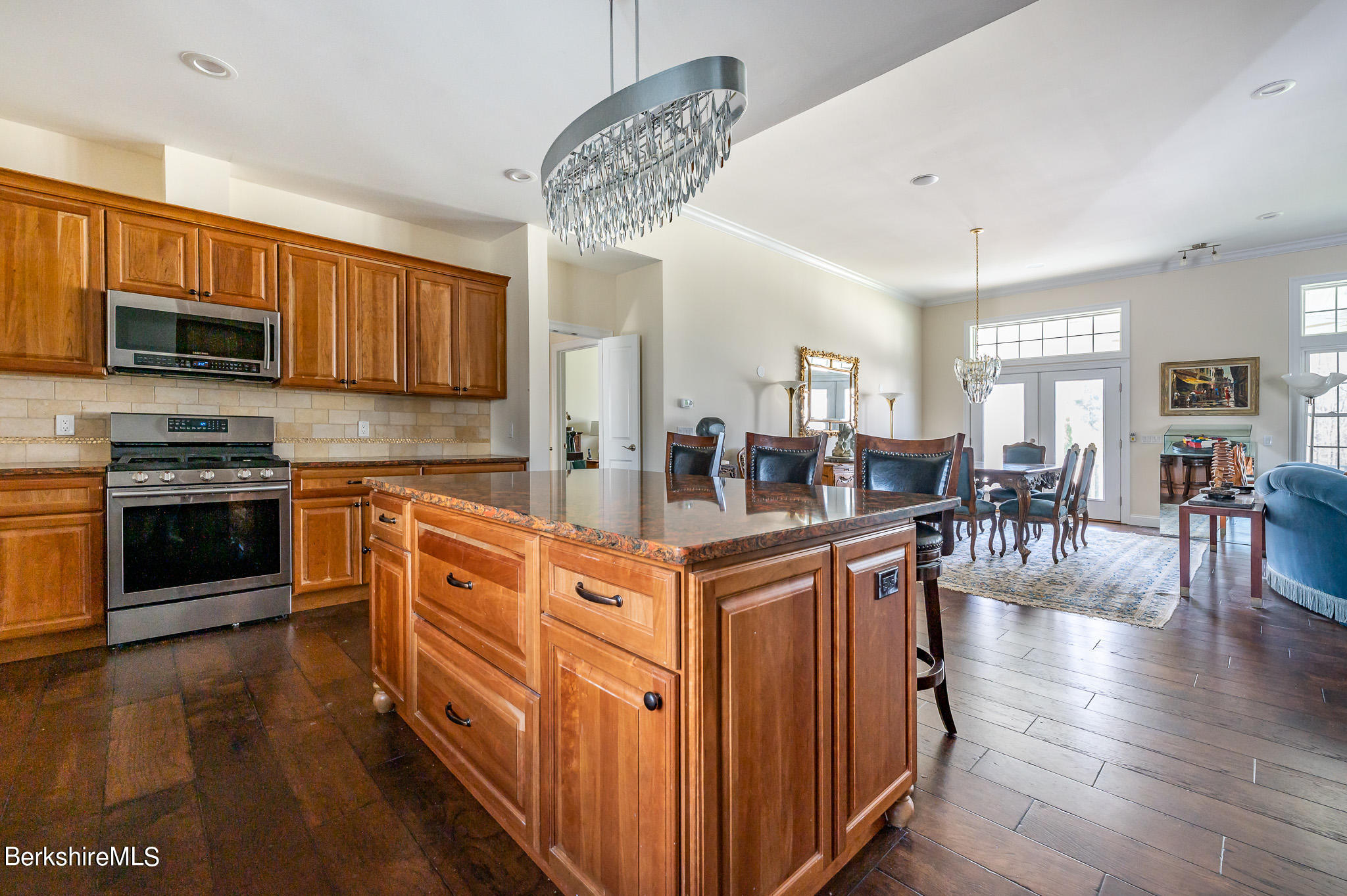 16 Burning Tree Road Great Barrington, MA 01230 - Photo 10 of 39 a kitchen with stainless steel appliances granite countertop a stove top oven a sink dishwasher a dining table and chairs with wooden floor