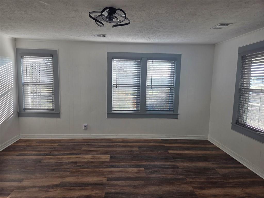 5465 Jot Em Down Road Cumming, GA 30041 - Photo 4 of 11 a view of empty room with wooden floor and fan