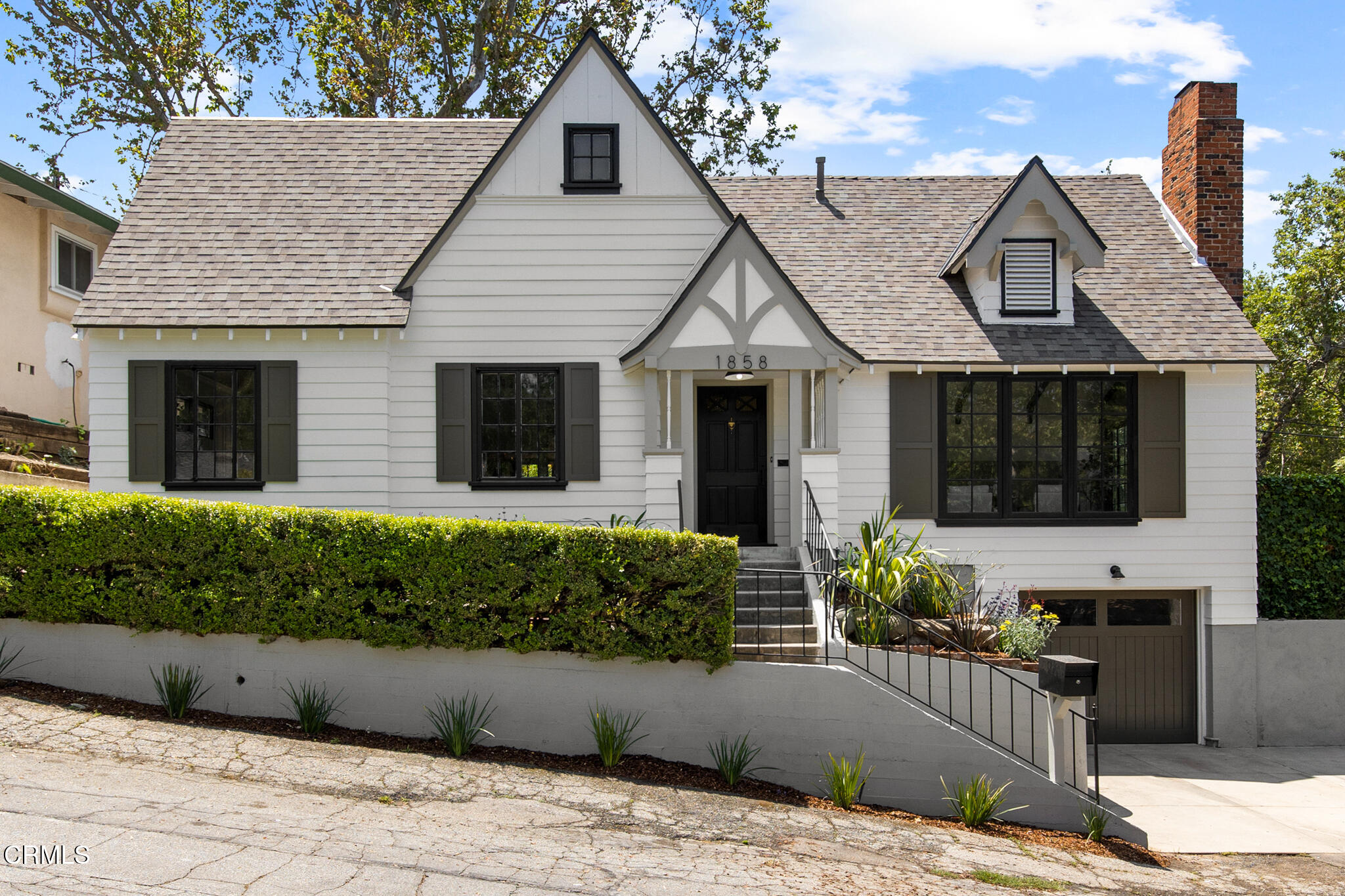 a front view of a house with garden