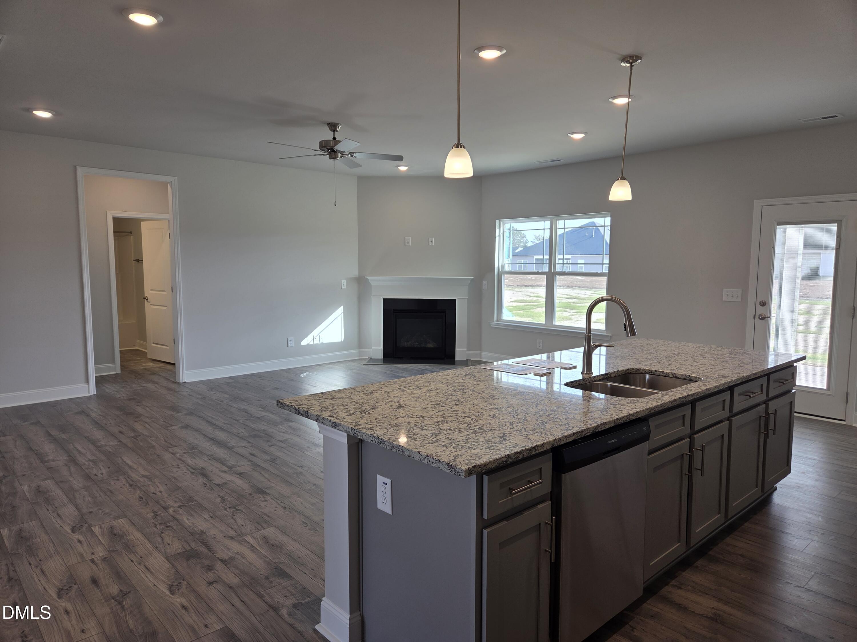4979 Trident Maple Court Battleboro, NC 27809 - Photo 12 of 41 a kitchen with granite countertop kitchen island a sink stainless steel appliances and a counter top space