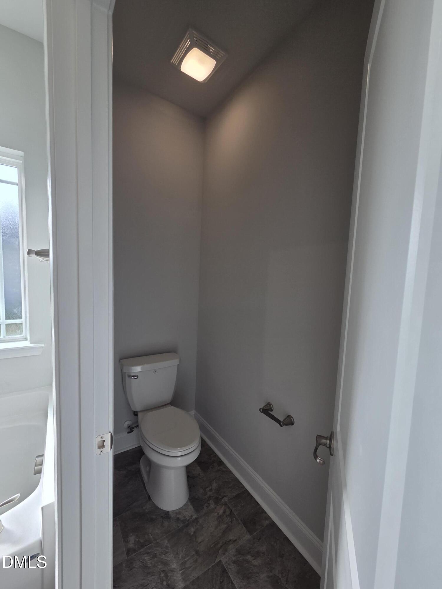 4979 Trident Maple Court Battleboro, NC 27809 - Photo 27 of 41 a white toilet sitting next to a small bathroom