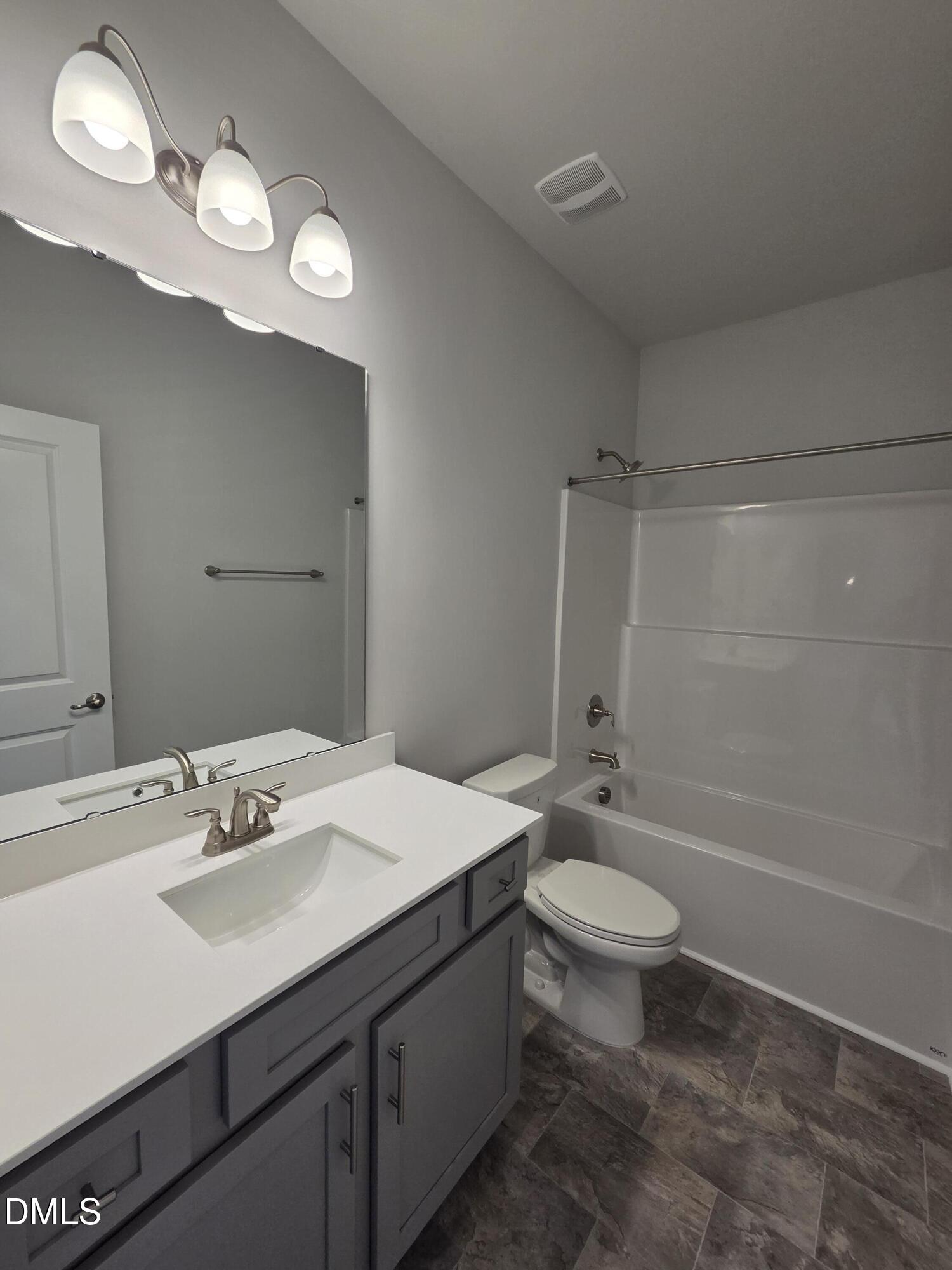 4979 Trident Maple Court Battleboro, NC 27809 - Photo 33 of 41 a bathroom with a sink a toilet a mirror and shower