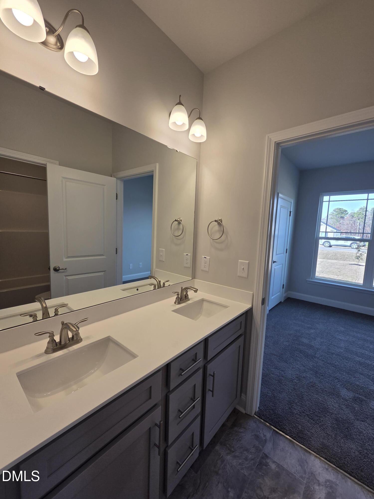 4979 Trident Maple Court Battleboro, NC 27809 - Photo 38 of 41 a bathroom with a sink double vanity granite and a mirror