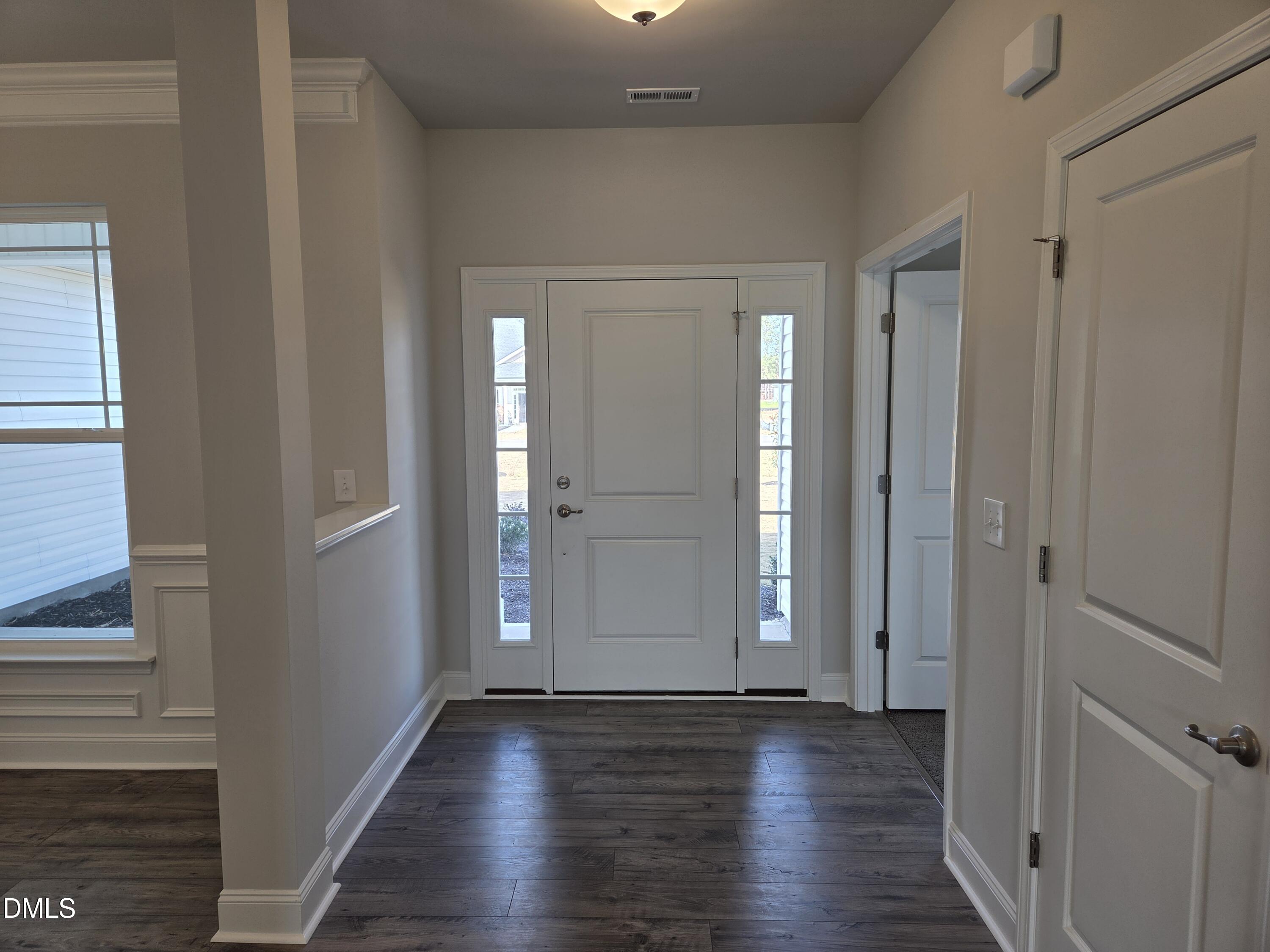 4979 Trident Maple Court Battleboro, NC 27809 - Photo 4 of 41 a view of an empty room with wooden floor and a window