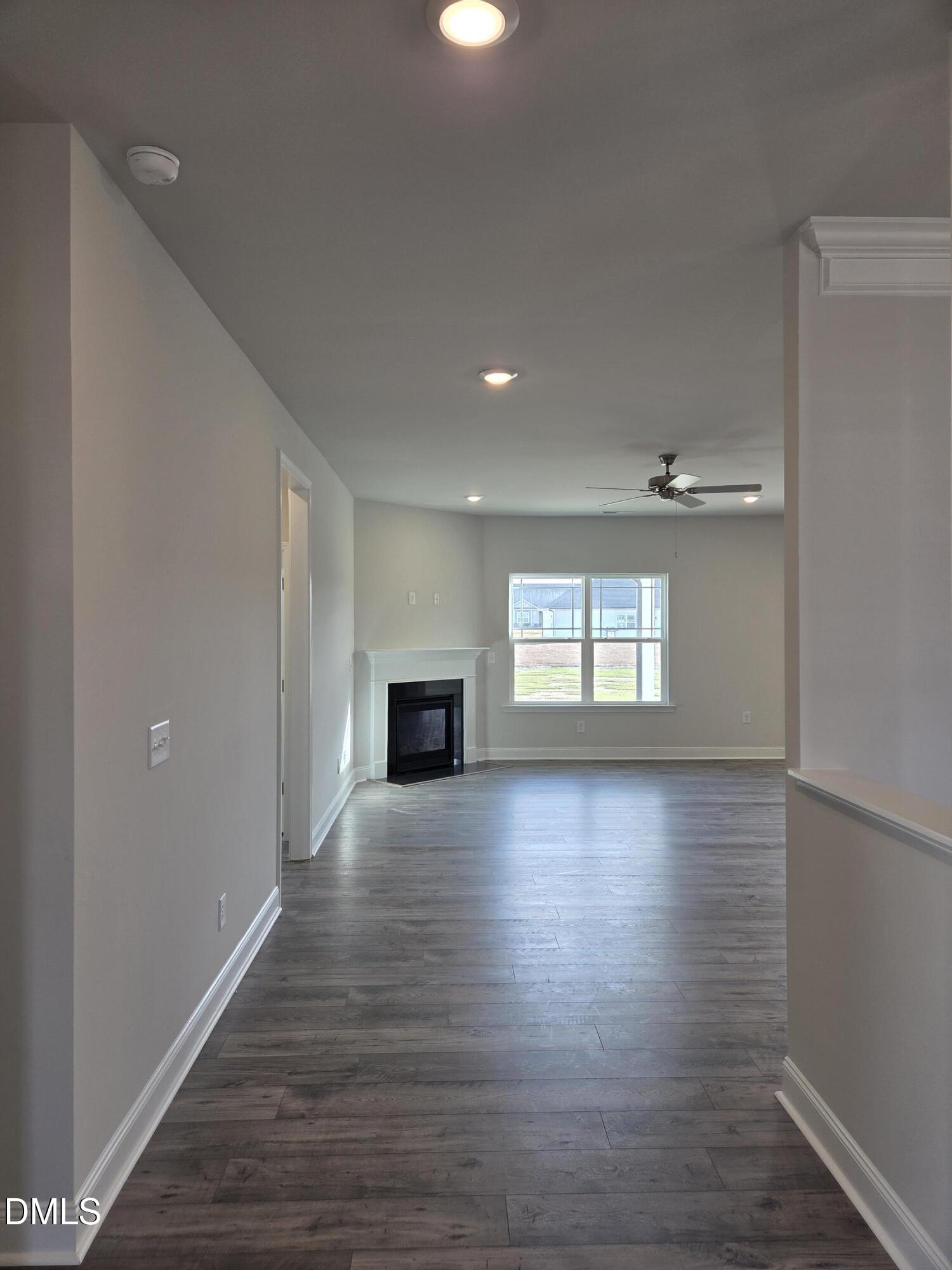 4979 Trident Maple Court Battleboro, NC 27809 - Photo 7 of 41 a view of empty room with wooden floor and fireplace