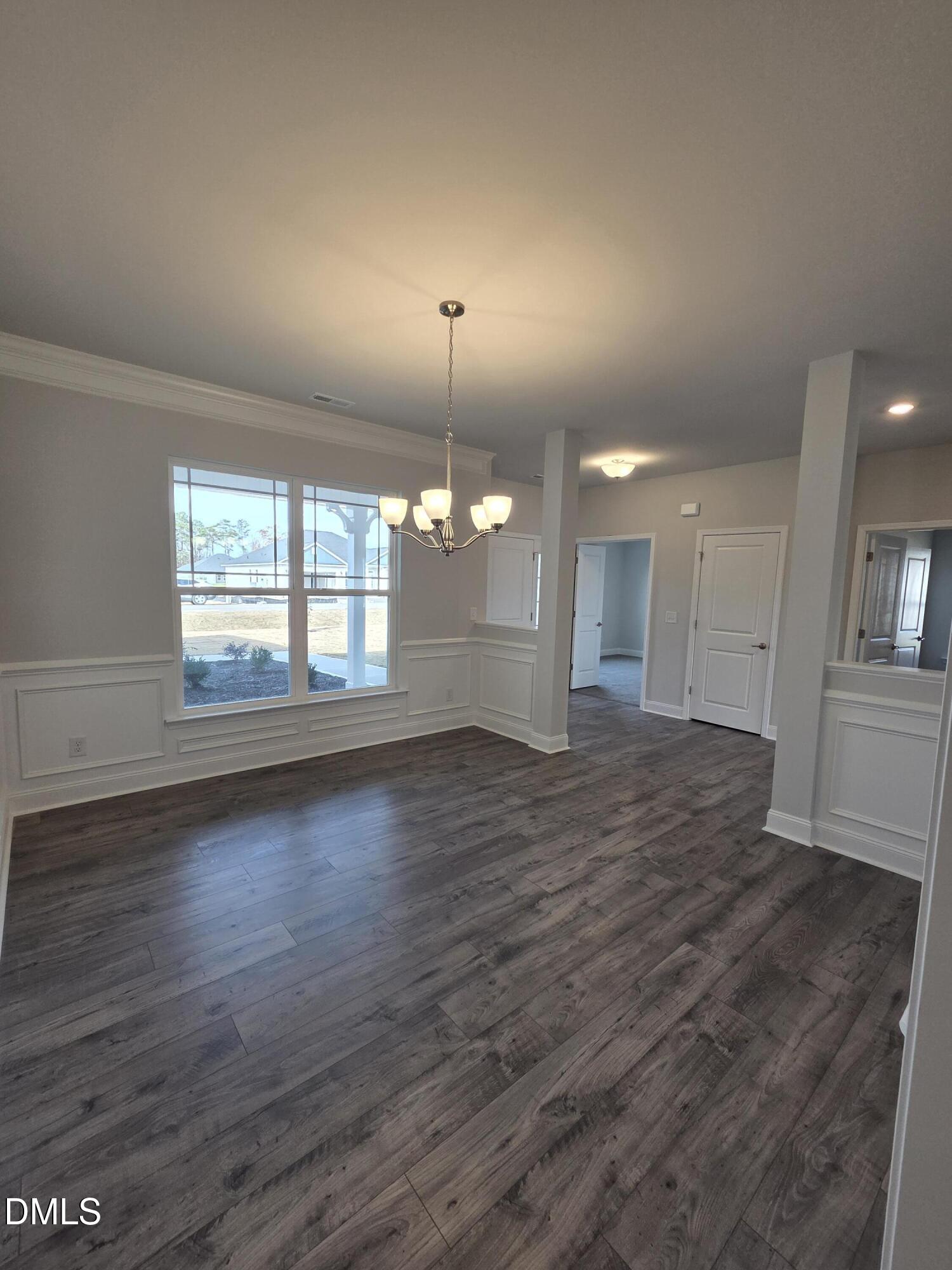 4979 Trident Maple Court Battleboro, NC 27809 - Photo 9 of 41 an empty room with wooden floor and windows