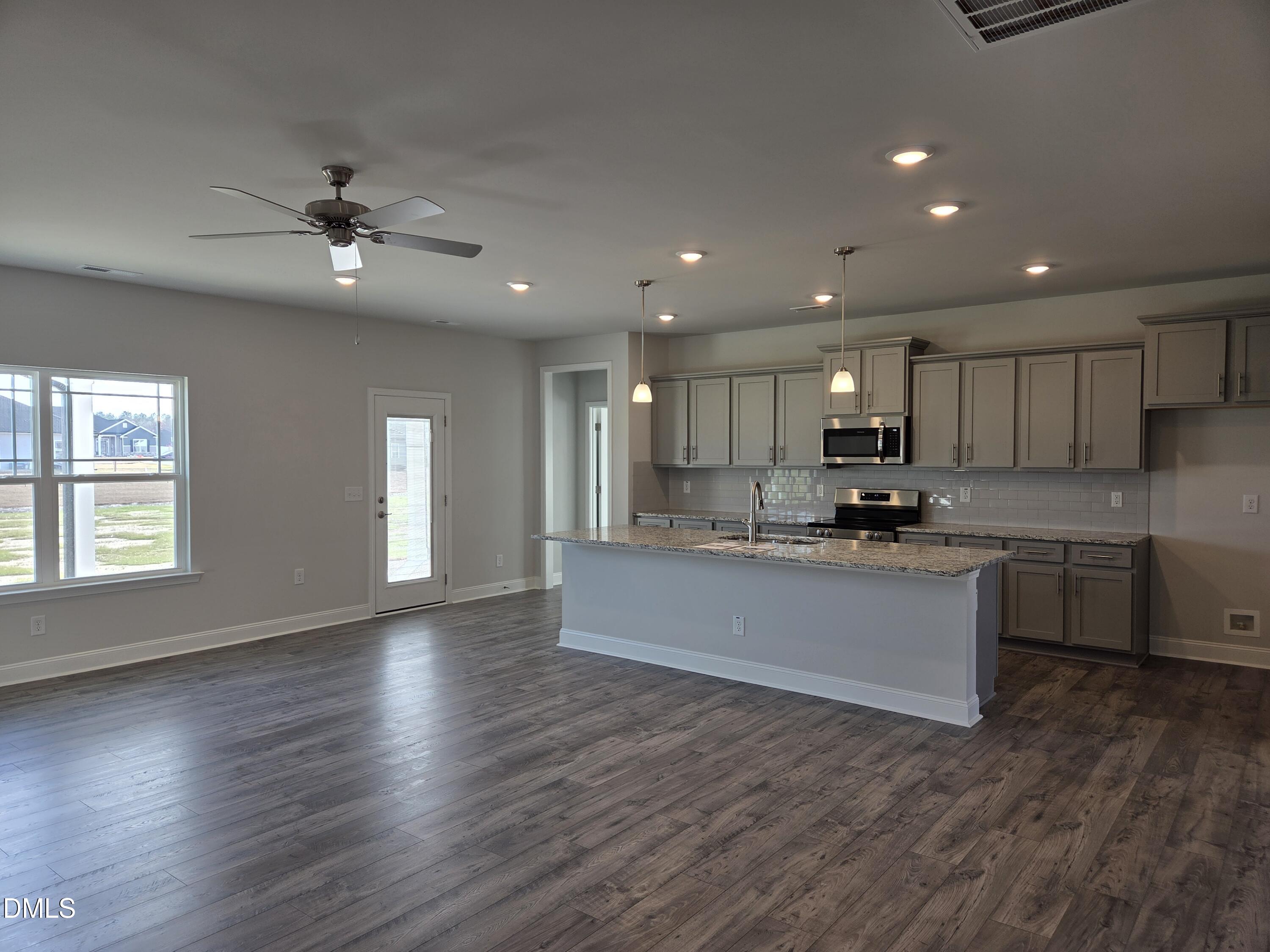 4979 Trident Maple Court Battleboro, NC 27809 - Photo 10 of 41 a large kitchen with stainless steel appliances granite countertop a large counter top a sink and a dishwasher