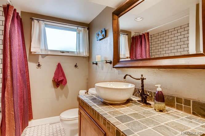 2917 Chase Street Wheat Ridge, CO 80214 - Photo 15 of 26 a bathroom with a sink toilet and shower