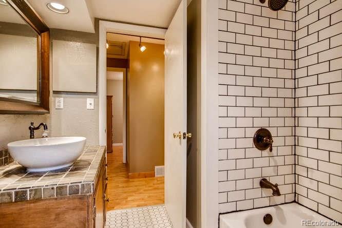 2917 Chase Street Wheat Ridge, CO 80214 - Photo 16 of 26 a bathroom with a bathtub and a shower