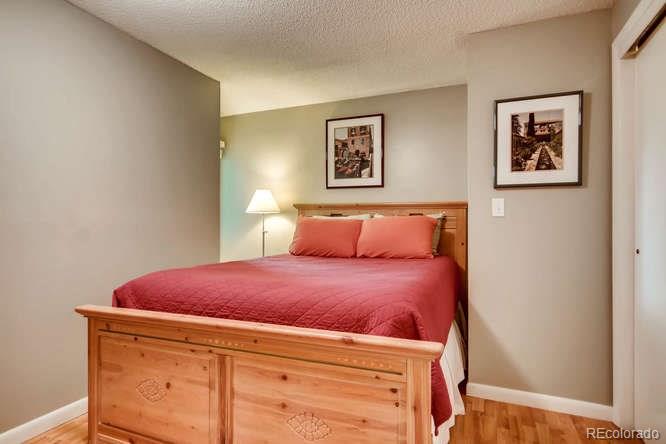 2917 Chase Street Wheat Ridge, CO 80214 - Photo 18 of 26 a bed room with a bed and painting on the wall