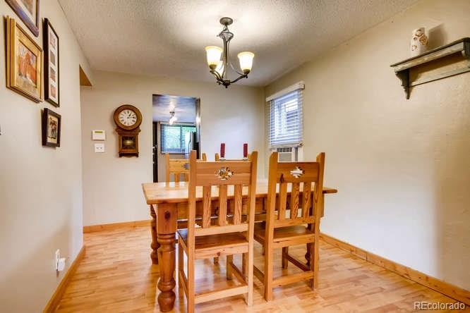 2917 Chase Street Wheat Ridge, CO 80214 - Photo 5 of 26 a view of a dining room with furniture and a chandelier