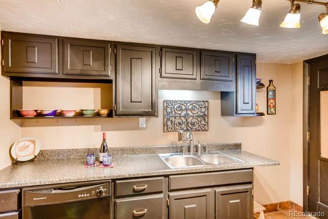 2917 Chase Street Wheat Ridge, CO 80214 - Photo 10 of 26 a kitchen with sink and cabinets