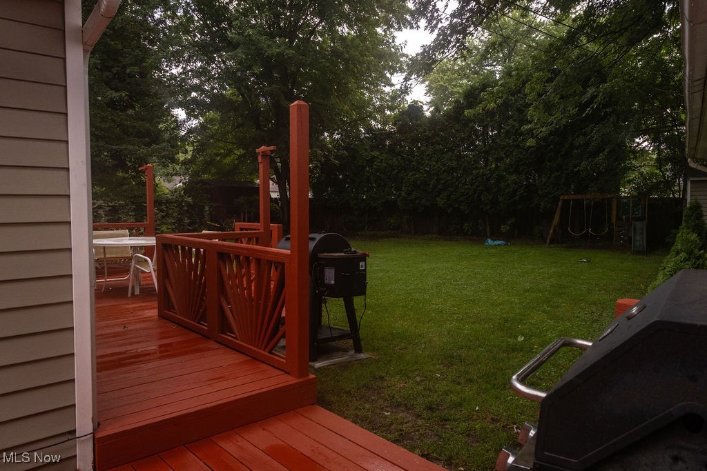 1995 Benjamin Road Madison, OH 44057 - Photo 7 of 50 Fenced backyard with a wooden deck and a playground