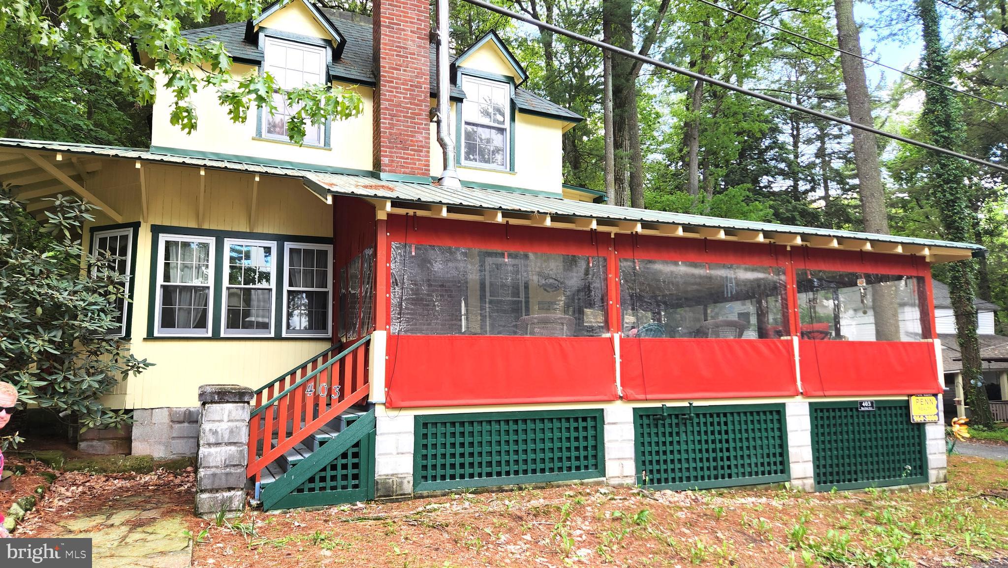 a view of a house with a yard and sitting space