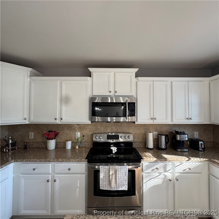 2020 Gray Goose Loop Fayetteville, NC 28306 - Photo 12 of 28 a kitchen with stainless steel appliances granite countertop a stove a sink and a white cabinets