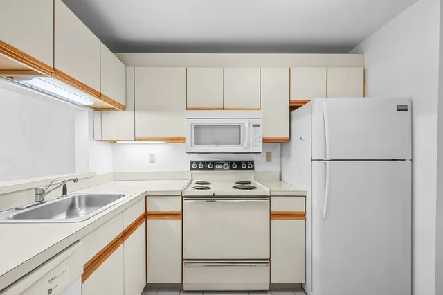a white refrigerator freezer sitting inside of a kitchen