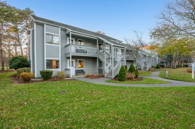 a view of a house with backyard porch and sitting area