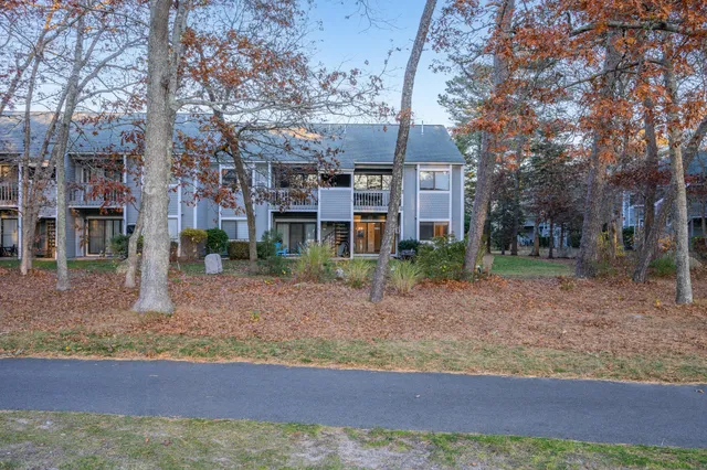 an aerial view of residential houses with outdoor space and river