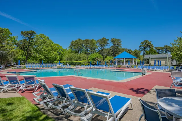a view of a chairs and table in patio with a yard