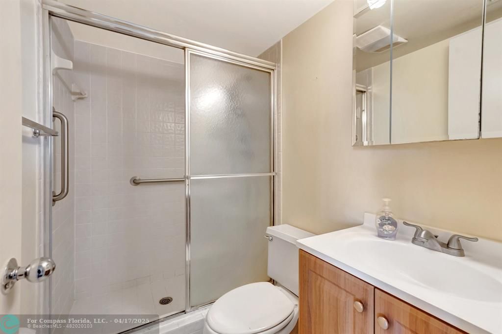5260 Northwest 2nd Avenue, Unit 504 Boca Raton, FL 33487 - Photo 15 of 23 a bathroom with a sink toilet and shower