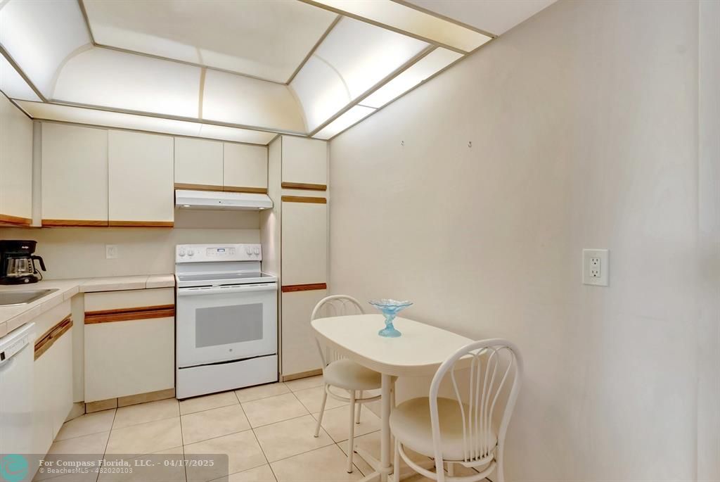 5260 Northwest 2nd Avenue, Unit 504 Boca Raton, FL 33487 - Photo 16 of 23 a kitchen with a sink cabinets and appliances