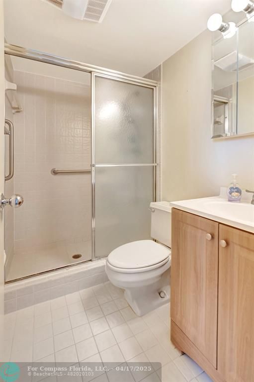 5260 Northwest 2nd Avenue, Unit 504 Boca Raton, FL 33487 - Photo 19 of 23 a bathroom with a toilet and a shower