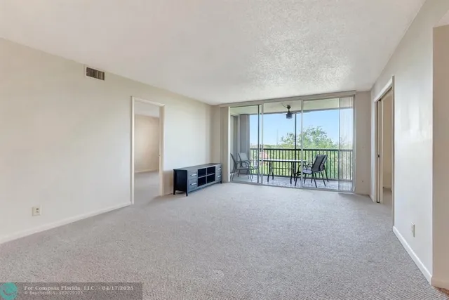a view of an empty room with a balcony