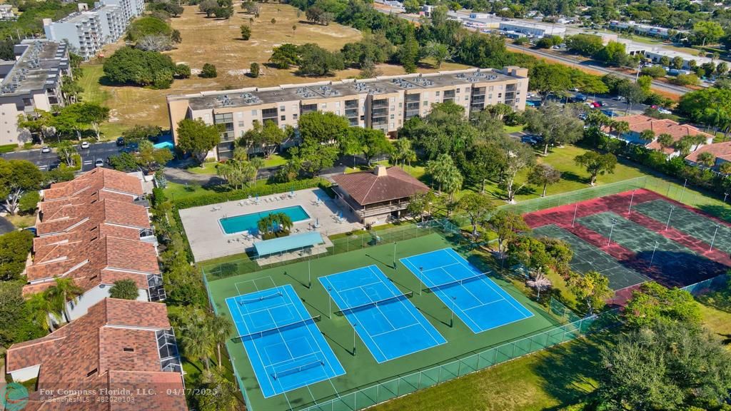 5260 Northwest 2nd Avenue, Unit 504 Boca Raton, FL 33487 - Photo 21 of 23 an aerial view of multiple houses with yard