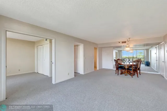 a view of a livingroom with furniture and chandelier