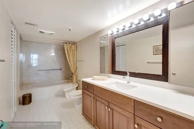 a bathroom with a double vanity sink mirror and shower