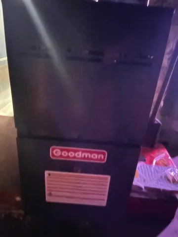 a room with water heater and wooden floor